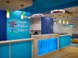 Roswell Pediatric Center's reception area with glowing blue counters, geometric lighting, and a full logo wall