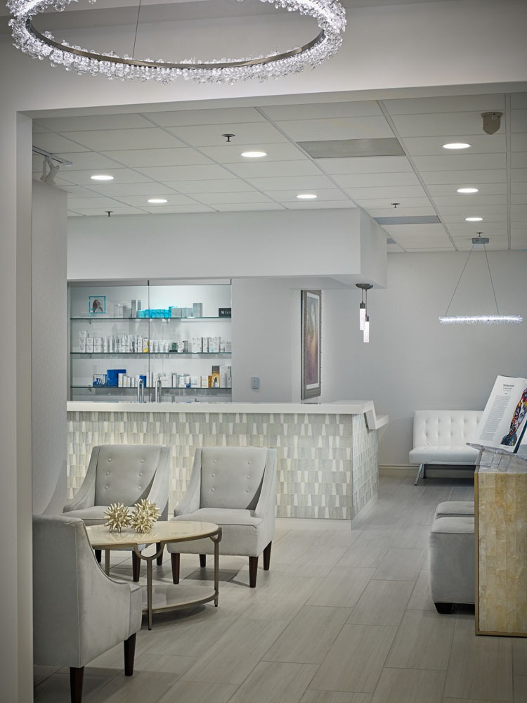 Luna Plastic Surgery & Medical Spa's pristine waiting area with product wall and diamond lighting