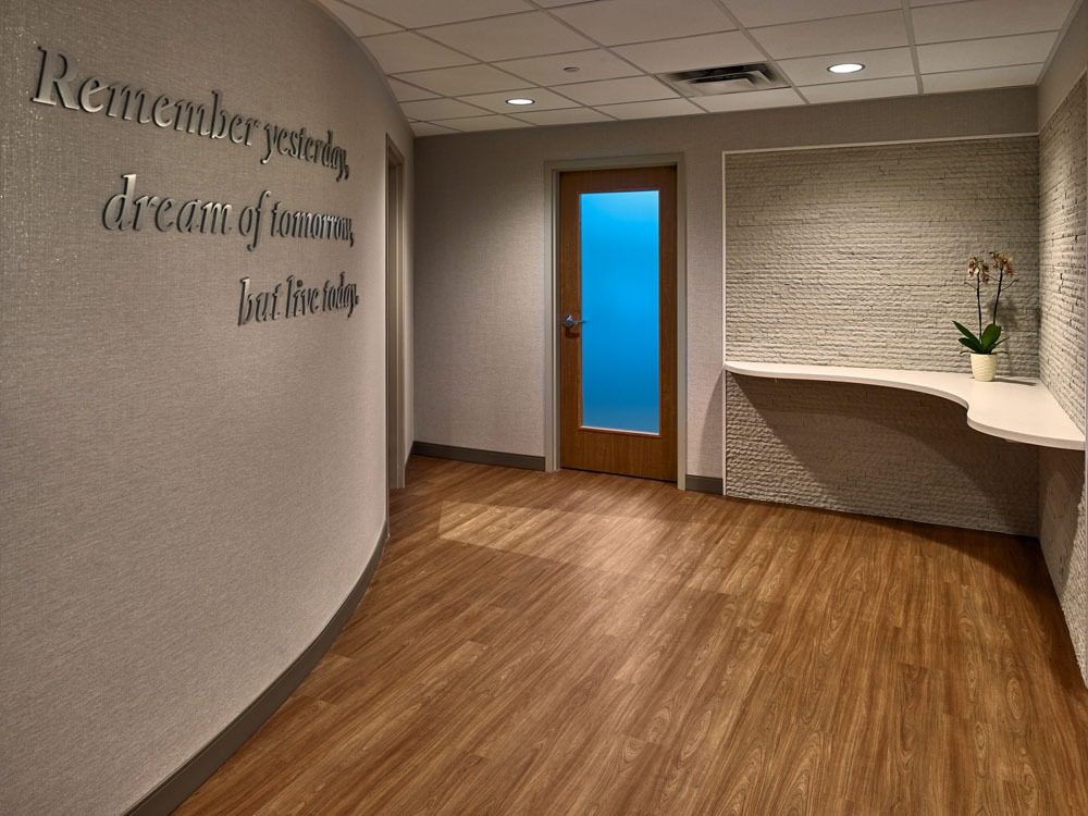Hallway in Wellstar Cobb Hospital with 3D signage, pristine wood floors, and modern decor