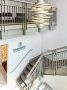 Radiance Surgery and Aesthetic Medicine's stairway with a modern chandelier and 3D signage