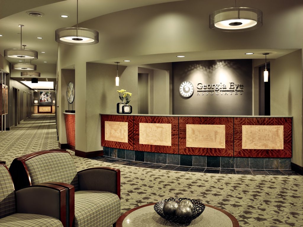 a reception area for Georgia Eye Associates with patterned flooring and a logo wall