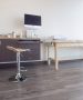 exam room with wall-mounted monitor, 3D spine replicas and wood flooring