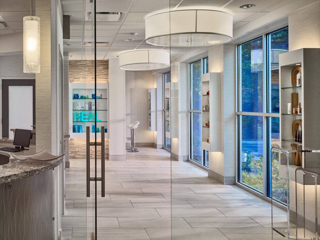 entryway to Premier Cosmetic and Laser Surgery with glass doors and backlit product display walls