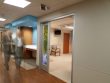 blurred image of two people walking through a hospital hallway