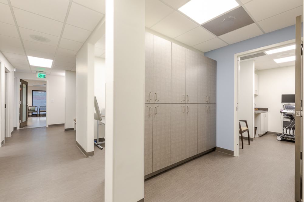 Comprehensive Women's OBGYN hallway view with modern storage cabinets and pillars