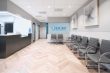 waiting room for Chacko Allergy, Asthma and Sinus Center with a row of gray chairs and framed wall photography