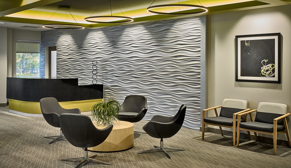 Axion Spine and Neurosurgery's waiting room with rounded chairs, yellow wall trim, and a textured accent wall