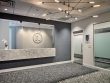 Robb Facial's reception area with a modern chandelier, sliding doors, and mounted logo